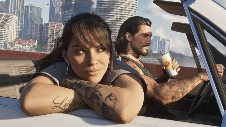 Characters from Grand Theft Auto VI cruising in an open-top car through a sunlit Vice City-style skyline